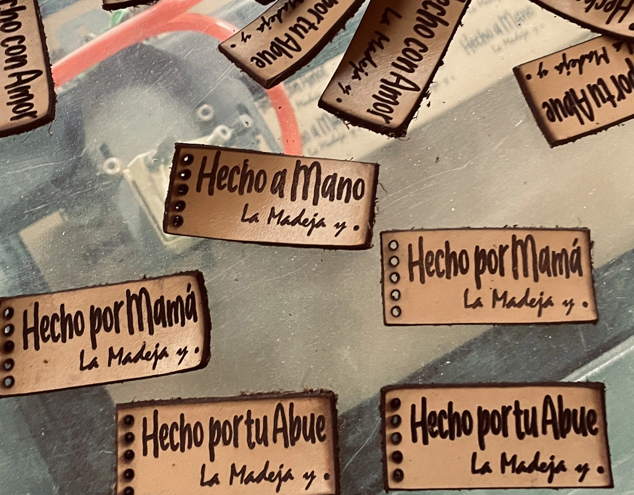 Etiquetas de madera con nombres y mensajes grabados.